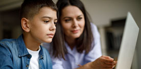 Mother and son looking at computer